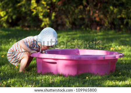 Child plays in sandpit on the playground