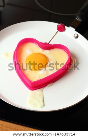 Frying Egg Sunny Side Up in Heart Shape Egg Ring