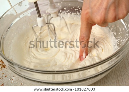 Making filling. Whipping cream. Making Chocolate Hazelnut Meringue Cake