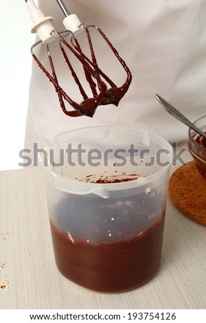Making ganache. Pour melted chocolate into whipped cream until just combined. Making Chocolate Hazelnut Meringue Cake
