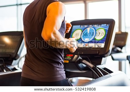 Athletic Runner Running on Treadmill in  Gym