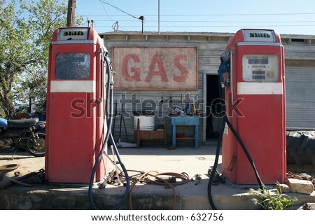 Old retro gas pumps in the rural landscape