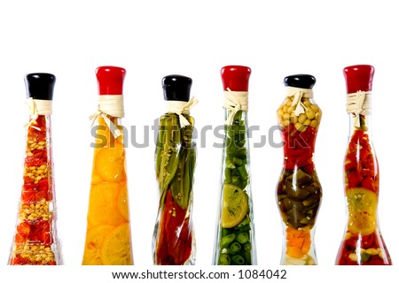 Decorative bottles with sealed colorful fruits and vegetables inside isolated on white.