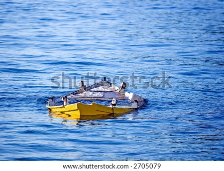 Abandoned small wooden fishing boat sunk in the sea