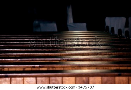 Rows of church pews with stream of light