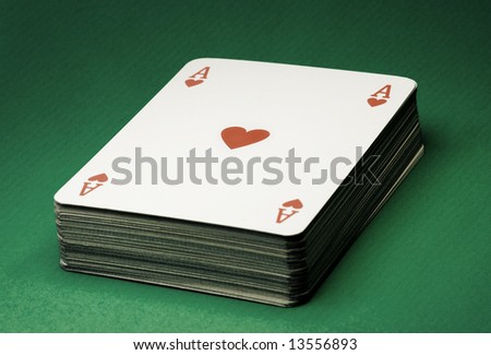 Deck of cards on green table , vintage style photo