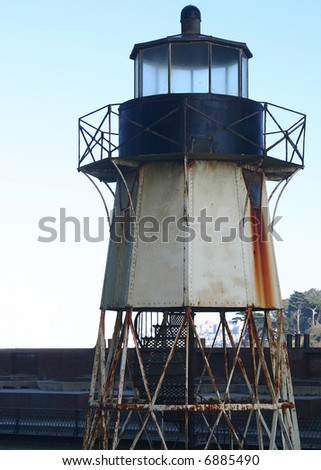 An Old Rusty light house that sits on top of the San Francisco Presido