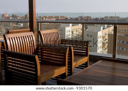 deck chairs at an outside bar on top of a hotel