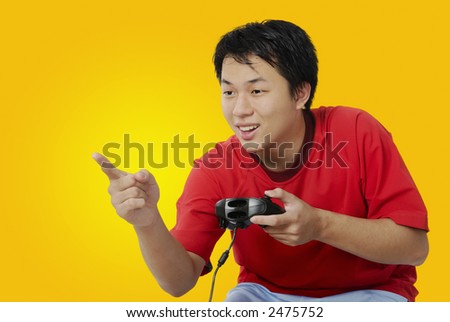 Handsome youth playing computer games.  He gestures that he has just won another point.
