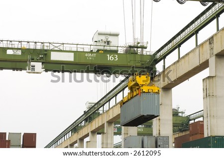 Sea freight container yard where cargo containers are being unloaded from yard storage area onto trucks