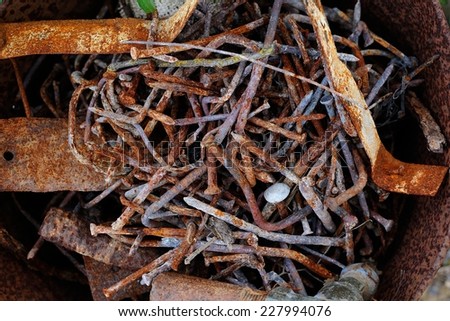 Corroded Nails; A bunch of rusty nails together with other corroded debris.