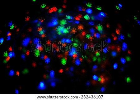 Christmas Sparkles; a set of blurred multicolored lights in snow flakes shape