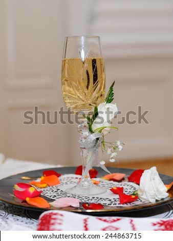 Wedding Champagne Glass; a champagne flute in a wedding style on a plate