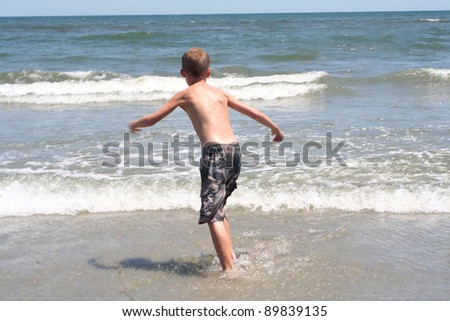 Boy Running Into Surf