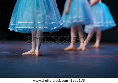 During a recital, one dancer stands out. Note: left dancer is in focus - enhanced to put right hand dancers more out of focus