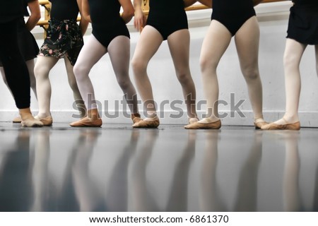 Young dancers are learning - they\'re all in a line trying to repeat what the instructor has shown them.