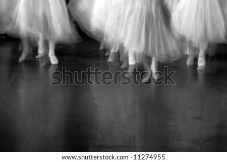Dancers on stage during a recital. Lots of motion evident - B&W