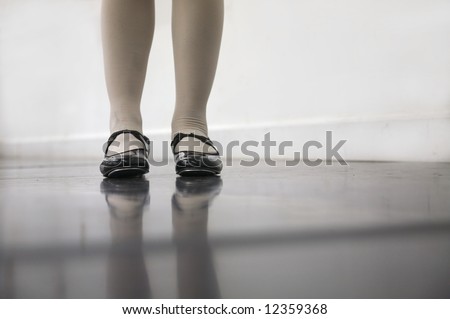 Young dancer in tap shoes... low angle shot of just feet and legs