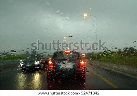 stopped at lights the car in the rain