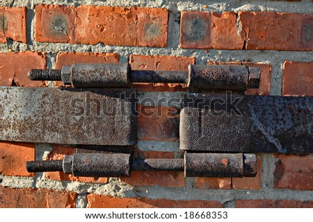 Metal coupler (bandage) on an old brick pipe of a boiler-house