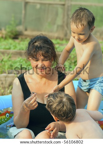 The grandmother and grandsons have a rest in pool