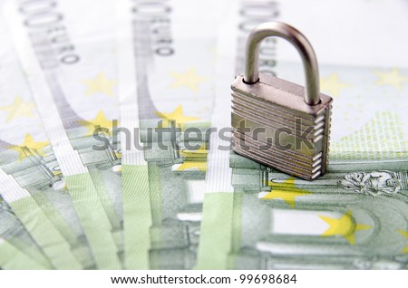 Picture of money with a key lock on top