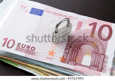 Picture of money stack with key lock on top