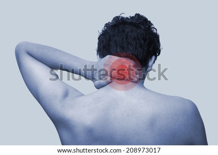 The young man keeps for neck. On a blue background