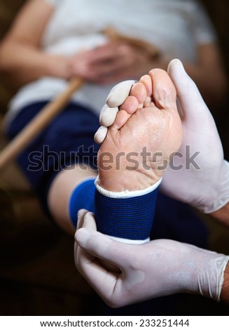 Doctor doing a bandage for patient. First aid