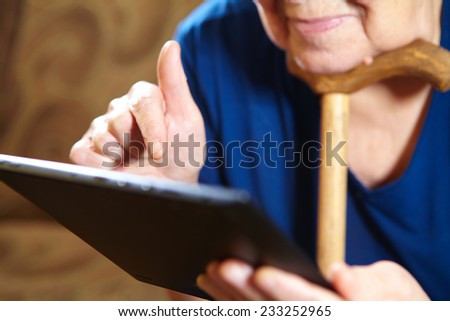 Elderly woman with tablet computer. Senior people using internet