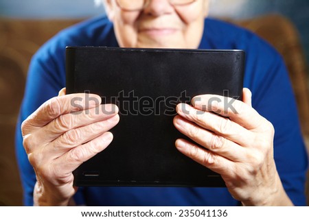 Elderly woman with tablet computer. Senior people using internet