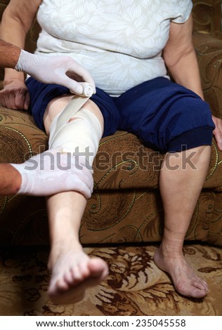 Doctor doing a bandage for patient. First aid