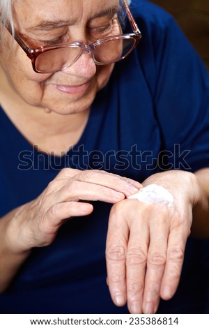 Senior woman with anti aging cream for hands