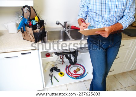 Plumber on the kitchen. Renovation  and plumbing.