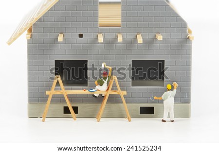 Construction of cottages. Workers at a construction site at home
