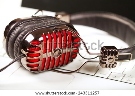 Microphone and headphones on the keyboard. Music and singing