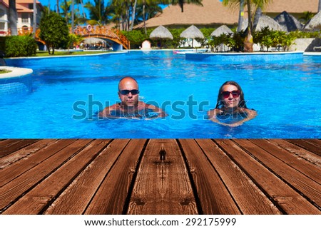 Happy couple swimming in pool. Sport and recreation background