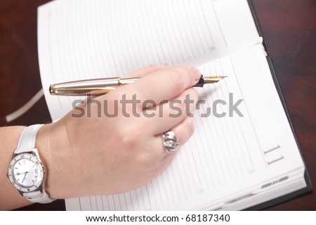 The businesswoman works at office. The document and pen