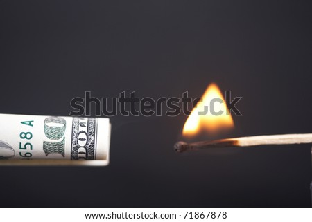 The burning match sets fire to dollar