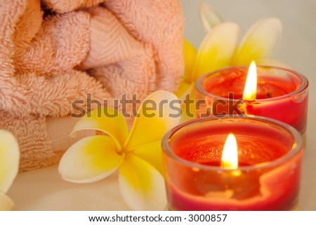 spa image of frangipani flowers and candles