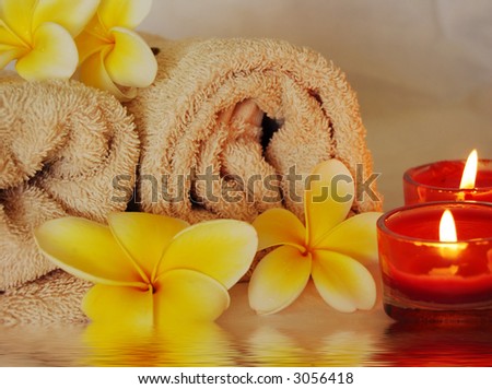 spa image of frangipani flowers, candles and towels