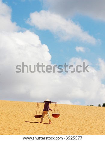 vietnamese woman carrying water in desert