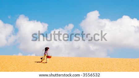 woman carrying water in desert