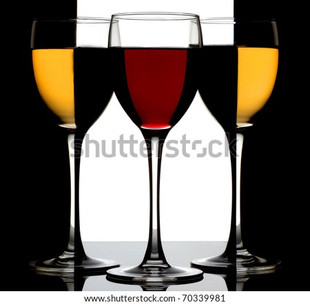Three wine glass with red and white wine over black-white background