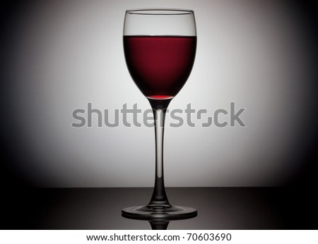 Glass of red wine over circle background