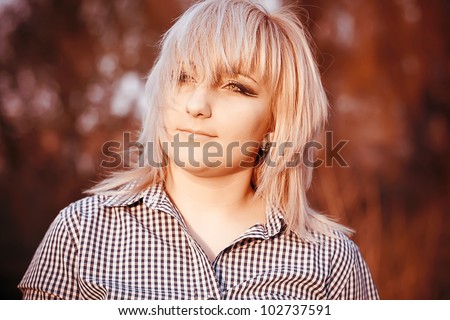 Beautiful young fashionable girl with makeup in the rays sun
