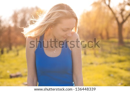 Girl frozen in the rays of the sun and shivering