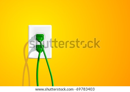 Electrical outlet with two green plugs and lots of copy space on the right.