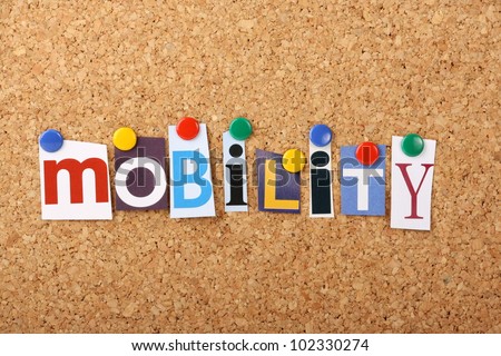 The word Mobility in cut out magazine letters pinned to a cork notice board