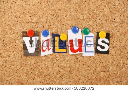 The word values in cut out magazine letters pinned to a cork notice board. May refer to social or business values.